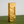 Gold lighter on a green surface with a gray background