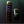 Two lighters, one tall and one compact, on a dark reflective surface.